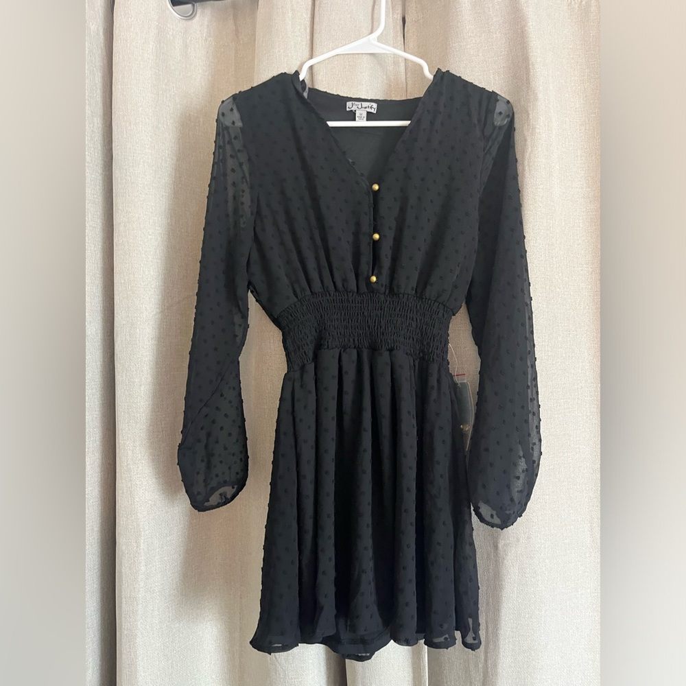 Black mini dress with gold buttons in the front & an elastic band in the middle.